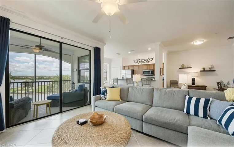 Open Living area with crown molding, ceiling fan, light tile patterned floors, recessed lighting, and a picturesque water view.