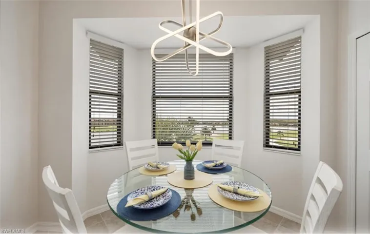 Pleasant Dining area with tile patterned flooring and a chandelier