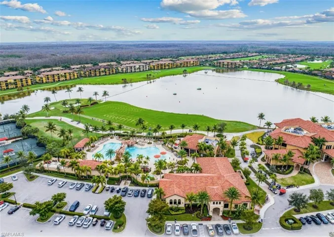 Drone / aerial view of a pool area and a large body of water