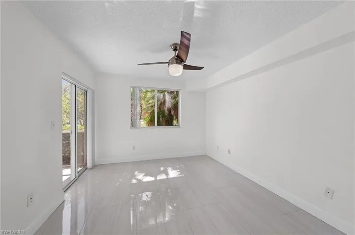 Unfurnished room featuring a textured ceiling and ceiling fan