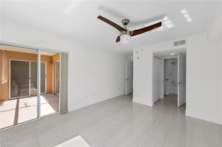 Unfurnished bedroom featuring ceiling fan, access to exterior, and light tile patterned flooring
