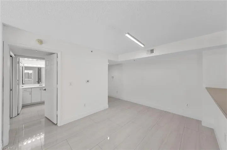 Empty room featuring baseboards and a textured ceiling
