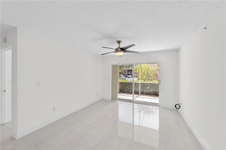 Unfurnished room with a textured ceiling and ceiling fan