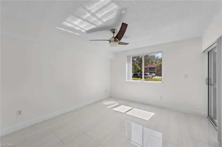 Unfurnished bedroom with ceiling fan and a textured ceiling