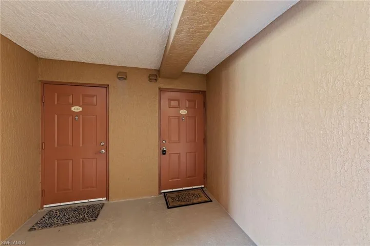 Entrance to property featuring stucco siding