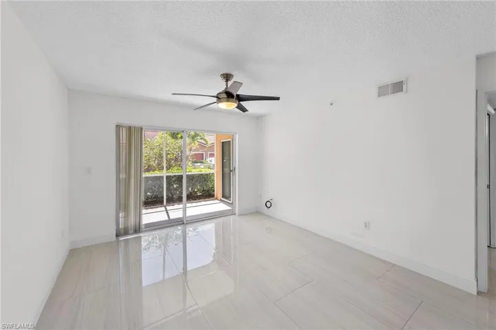 Empty room featuring a textured ceiling and a ceiling fan