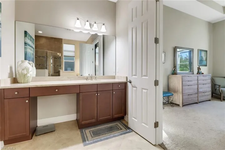 Master bath with his and her vanities, make-up section and tile floor.