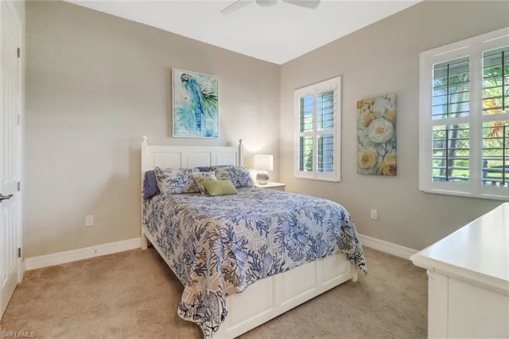 Guest bedroom with plantation shutters.