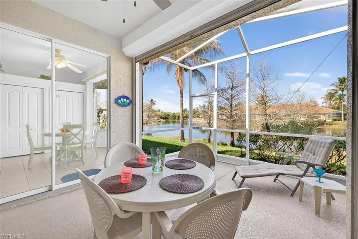 Sunroom with outdoor dining space, a ceiling fan, a water view, and healthy amount of natural light