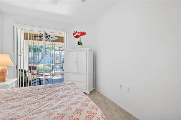 Bedroom with access to outside, light carpet, and ceiling fan