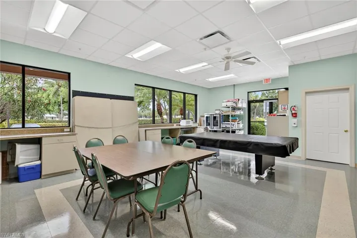 Dining space featuring a drop ceiling and ceiling fan