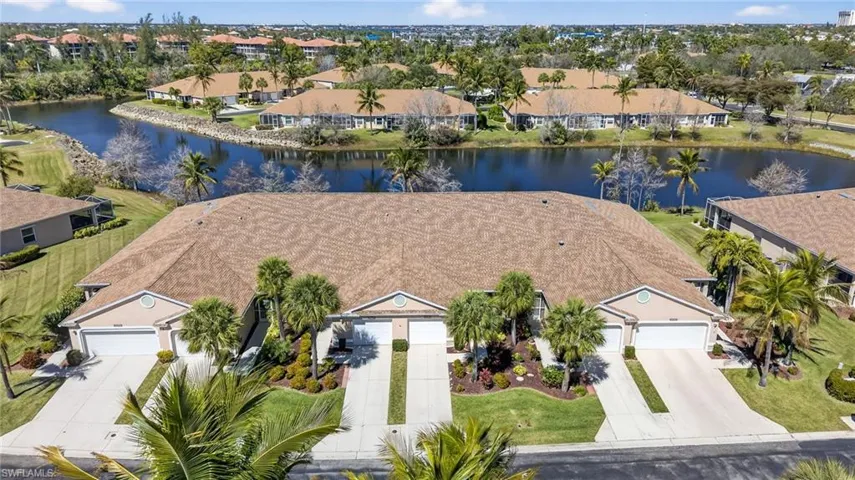 Aerial perspective of suburban area featuring a nearby body of water