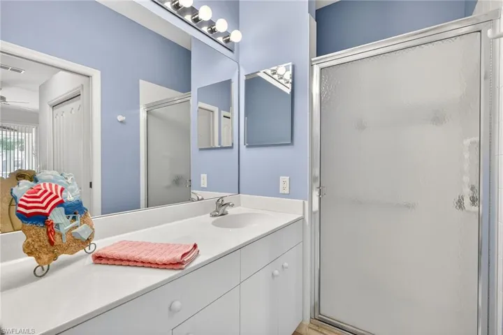 Bathroom with vanity and a stall shower