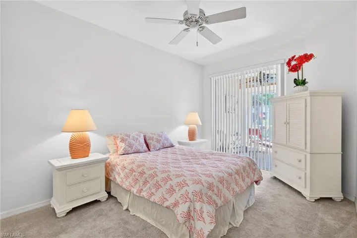 Bedroom with light colored carpet and a ceiling fan