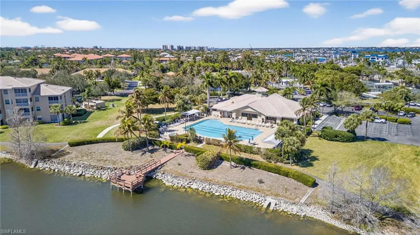 Aerial view of a pool area and a nearby body of water