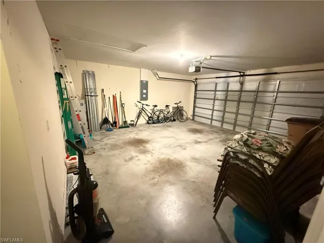 Garage with electric panel and a garage door opener