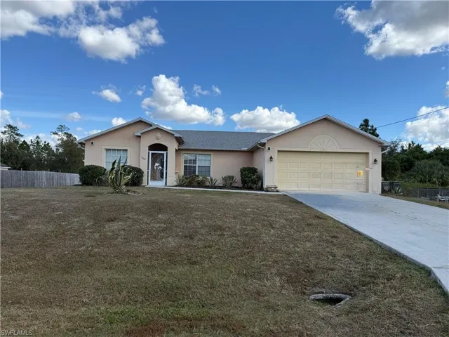 Single story home featuring stucco siding, concrete driveway, and a garage