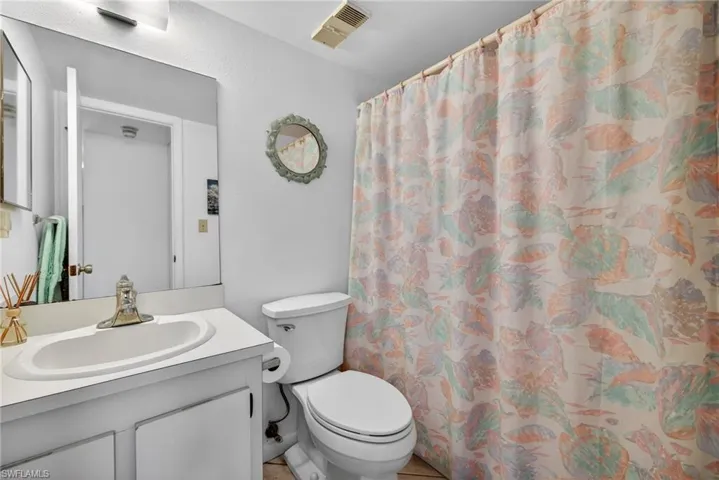 Bathroom with vanity and curtained shower