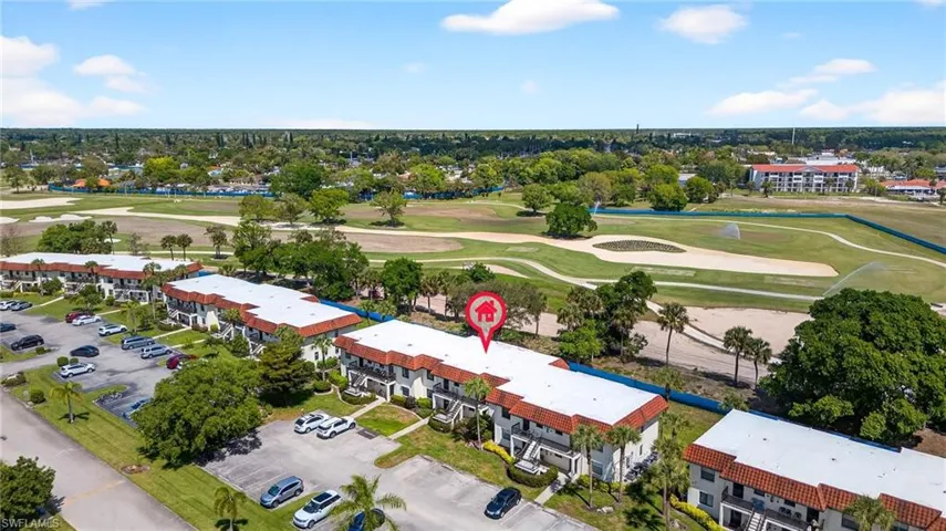 Aerial view of apartment complex and a local golf course