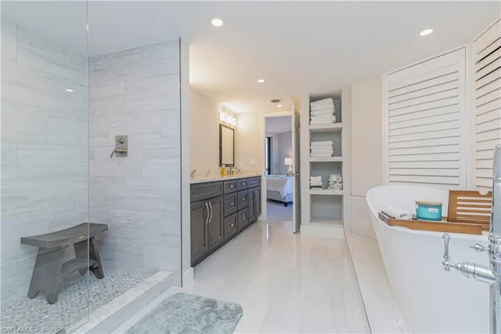 Bathroom featuring vanity and shower with separate bathtub