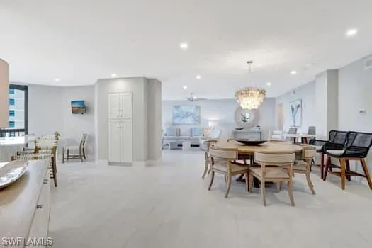 Dining room with an inviting chandelier and recessed lighting