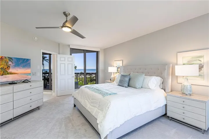 Carpeted bedroom with access to outside and ceiling fan