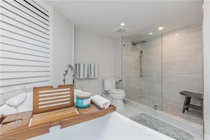 Bathroom with toilet and tiled shower