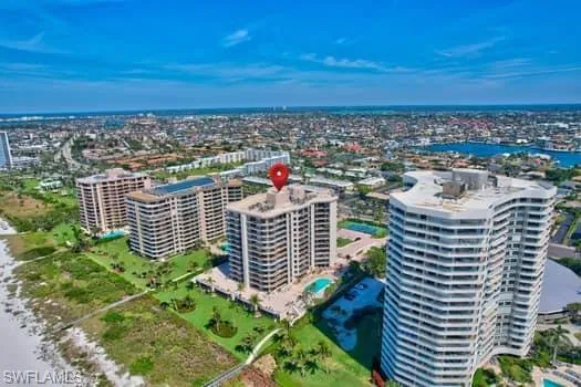 Aerial view featuring a city view and a water view