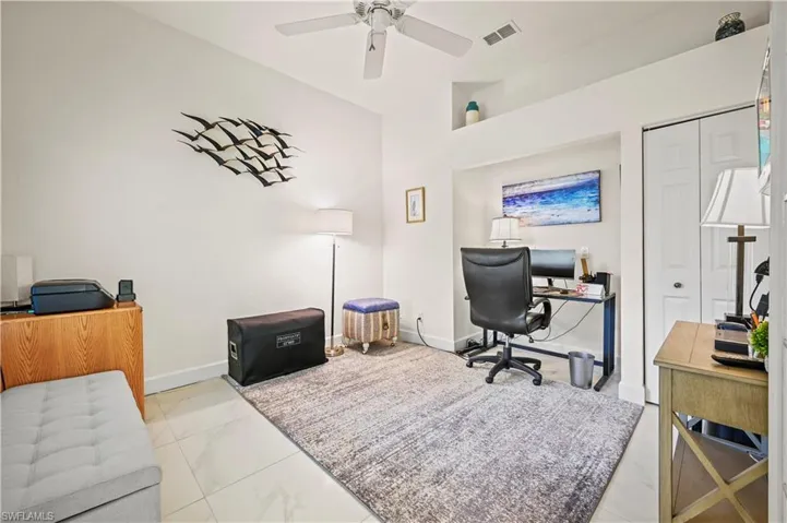 Home office featuring ceiling fan and light tile patterned floors