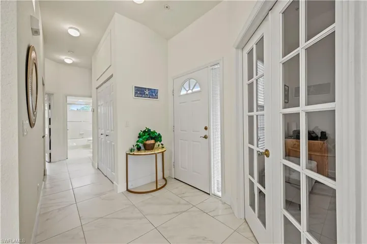 Foyer featuring light tile patterned floors