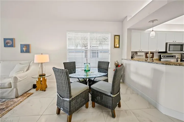 Dining space with light tile patterned floors