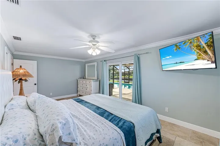 Bedroom featuring Crown molding and access to spacious lanai