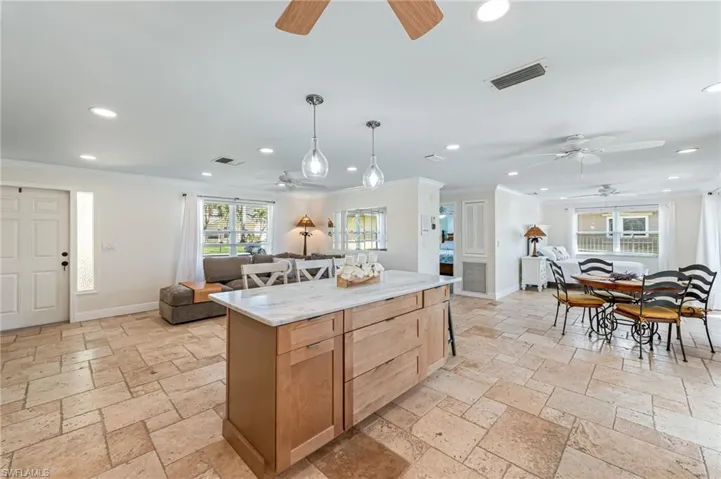 Travertine Flooring coupled with two tone kitchen cabinets