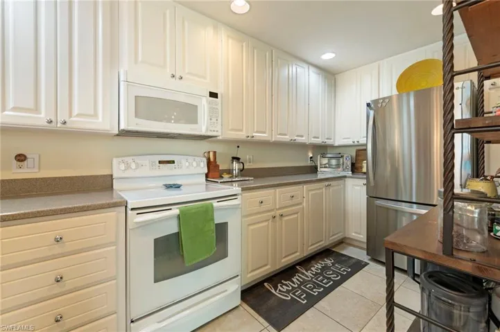 5361 Laughing Gull Ln. Bonita Springs FL 34135 - Kitchen with white cabinets and recessed can lighting