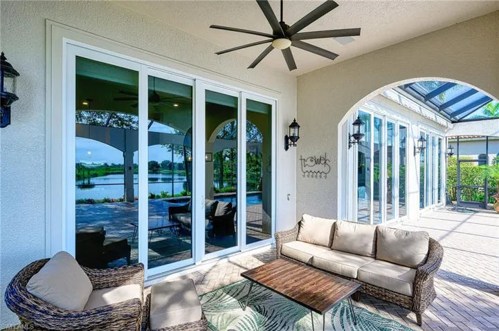 View of patio with ceiling fan, an outdoor hangout area, french doors, and a water view