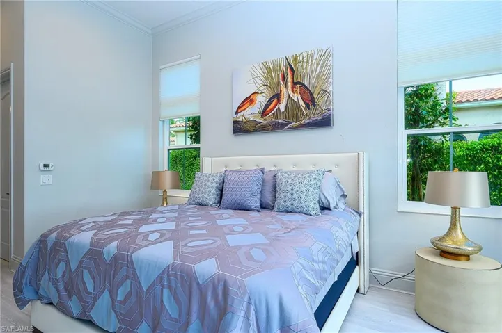 Bedroom featuring light wood-type flooring and crown molding