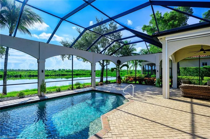 View of pool featuring ceiling fan, a patio, and a lanai