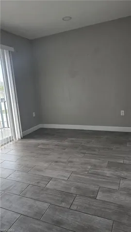 Unfurnished room featuring wood finish floors