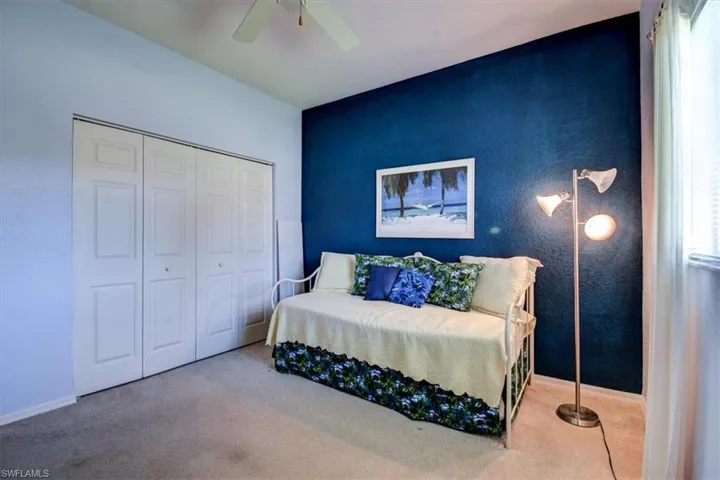 Bedroom with carpet flooring, a closet, and a ceiling fan