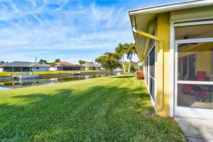 View of grassy yard featuring a water view and a residential view