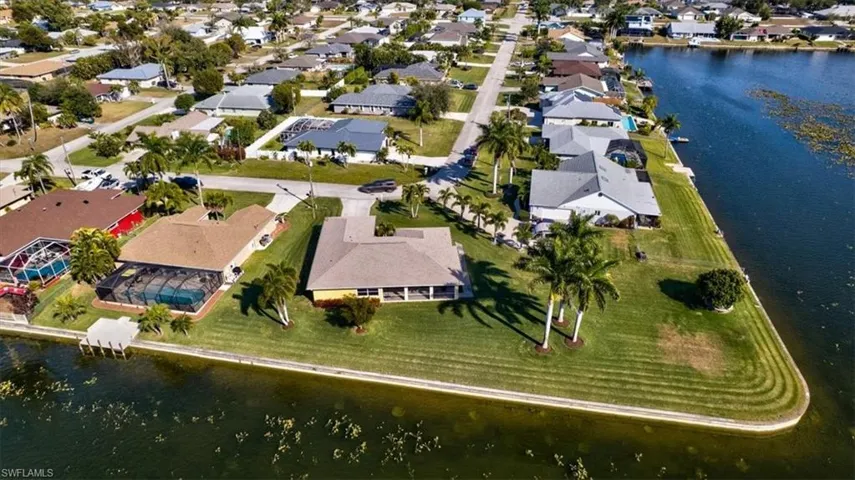 Aerial overview of property's location featuring a nearby body of water and nearby suburban area