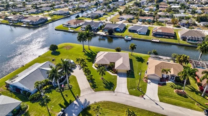 Aerial view of property's location with nearby suburban area and a large body of water