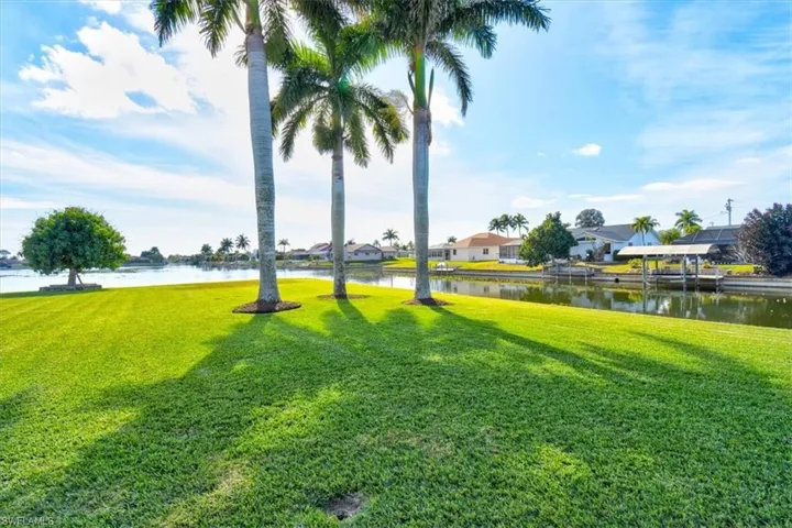 View of green lawn featuring a water view and a residential view