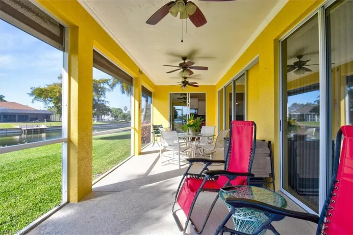 Sunroom / solarium with outdoor dining space and a water view
