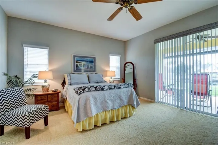 Bedroom featuring carpet, access to outside, and ceiling fan