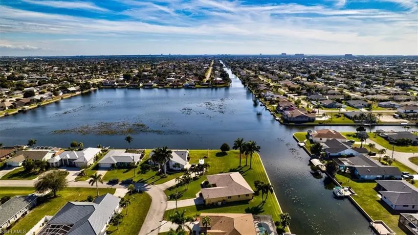 Aerial perspective of suburban area featuring a large body of water