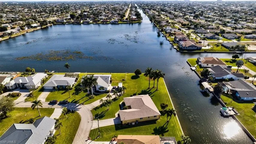 Aerial view of property's location featuring nearby suburban area and a nearby body of water