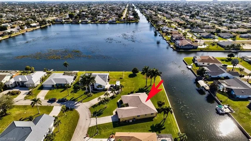 Aerial overview of property's location with nearby suburban area and a nearby body of water