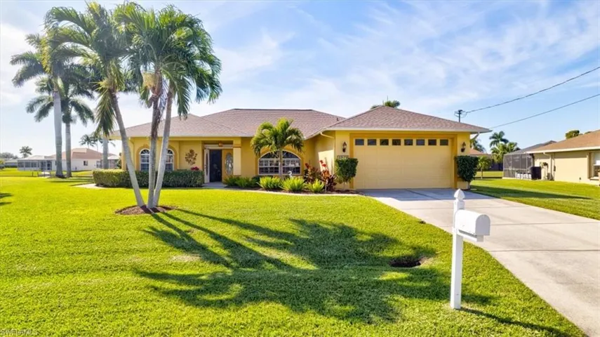 Ranch-style home with a front yard, concrete driveway, an attached garage, and stucco siding