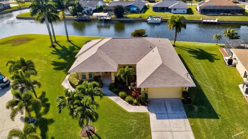 Aerial view of residential area featuring a nearby body of water